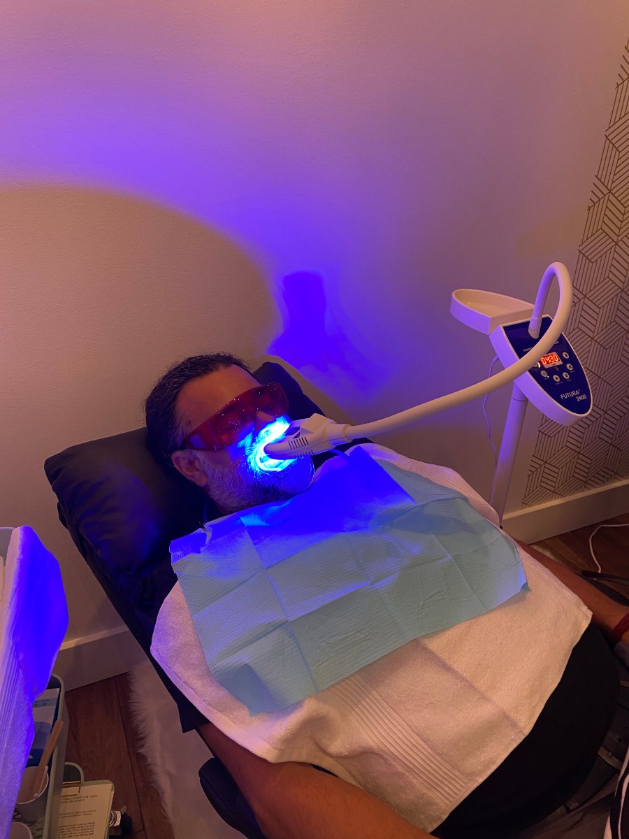 A client under the Brite Lite 6200 during a whitening session